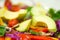 Closeup fresh colourful salad with purple cole, avocado and tomato mixed together