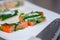 Closeup of the fresh delicious salmon wrapped in perilla leaves on the plate