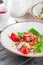 Closeup of a fresh green salad with sliced seared tenderloin steak