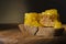 Closeup of fresh honeycomb,piece of rye bread on the wooden boardagainst dark background