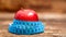 Closeup fresh red apple with measuring tape isolated on wooden background. Slim diet and eating for health.