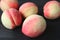 Closeup Fresh Ripe Peaches Scattered on Black Wooden Table