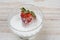 Closeup of a Fresh Strawberry in a Bowl of Sugar