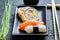 Closeup of fresh sushi, dark ceramic and chopstick