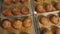 Closeup of freshly baked burger buns with sesame seeds in the restaurant kitchen