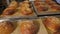 Closeup of freshly baked burger buns with sesame seeds in the restaurant kitchen