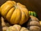 Closeup of freshly harvested Nutmeg pumpkins stacked on one another with a blurry background