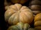 Closeup of freshly harvested Nutmeg pumpkins stacked on one another with a blurry background