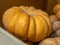 Closeup of freshly harvested Nutmeg pumpkins stacked on one another with a blurry background