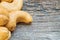 Closeup fried cashew nut on old wood desk textured background