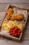 Closeup fried chicken legs and french fries with marinated tomatoes