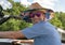 Closeup front view of a forty-four year-old Caucasian man driving a ski boat on Grand Lake in Oklahoma.