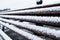 Closeup Frozen bench covered gritty rough hoarfrost on a cloudly winter day