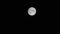 Closeup of a full moon shining in the dark night sky