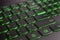 Closeup of gamer laptop keyboard green illumination, backlit keyboard, english letters