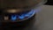 Closeup of gas fire under pot in kitchen. Blue gas flames burning