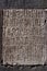 Closeup of Geghard rock monastery wall with armenian inscriptions