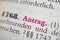 Closeup of the german word Antrag written in pink bold font 
Translation- application