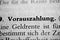 Closeup of the german word Vorauszahlung written in bold font surrounded by blurred words