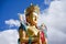 Closeup giant Maitreya Buddha statue with blue sky with clouds.