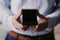 Closeup of gift on male hands. Man in blue shirt. Unrecognizable man holding opening black present box. Special day and festive ev