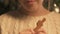 Closeup of girl biting gingerbread cookie, child delighted with Christmas bakery