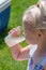 Closeup of girl drinking lemonade outside in summer