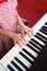 Closeup girl hand playing piano. Favorite music for learning to basic of music and rhythm skill.