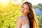 Closeup of girl posing outside in nature on a sunny day