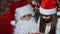 Closeup girl receives a gift from Santa Claus