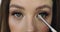 Closeup of girl s eyes with perfect nude make-up. Make-up process for beautiful young female model.