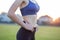 Closeup of a girl slim body in sports clothes. Flat stomach as result of physical training