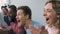 Closeup of girl watching football with friends, cheering for favourite team