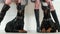 Closeup of girls legs wearing black leather and suede high heels boots near two doberman pinschers