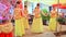 Closeup Girls in Yellow Costumes Dance on Stage at Wedding Party