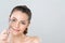 Closeup glamorous woman correct eyelash curler with alluring facial makeup