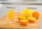 Closeup on glass of fresh orange juice and oranges