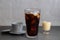 Closeup of a glass of iced coffee, condensed milk and a Vietnamese coffee filter