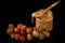 closeup glass jar with peanut butter next to purple grapes