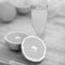 Closeup on glass of orange juice and oranges on cutting board