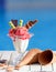 Closeup of glass with strawberry ice cream on blur bokeh background with copy space. Raspberry sorbet with waffle chocolate cones