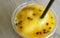 Closeup a Glass of Sweet and Sour Mango with Passion Fruit Smoothie on Wooden Table