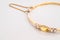 Closeup gold bracelet with yellow pebble on gray marble stone background