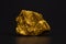 Closeup of gold nugget or gold ore on black background, precious
