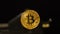 Closeup Golden Shining Bitcoin Model with Dropped Water