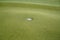 Closeup of a golf hole on the field