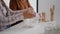 Closeup of grandmother hands putting flour in strainer while granddaughter sift ingredient