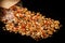 Closeup granola with assorted seeds scattered from kraft bag