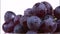 Closeup of grapes rotating on whit background