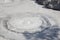 Closeup of gray mud boiling bubble hell hot springs at Japan